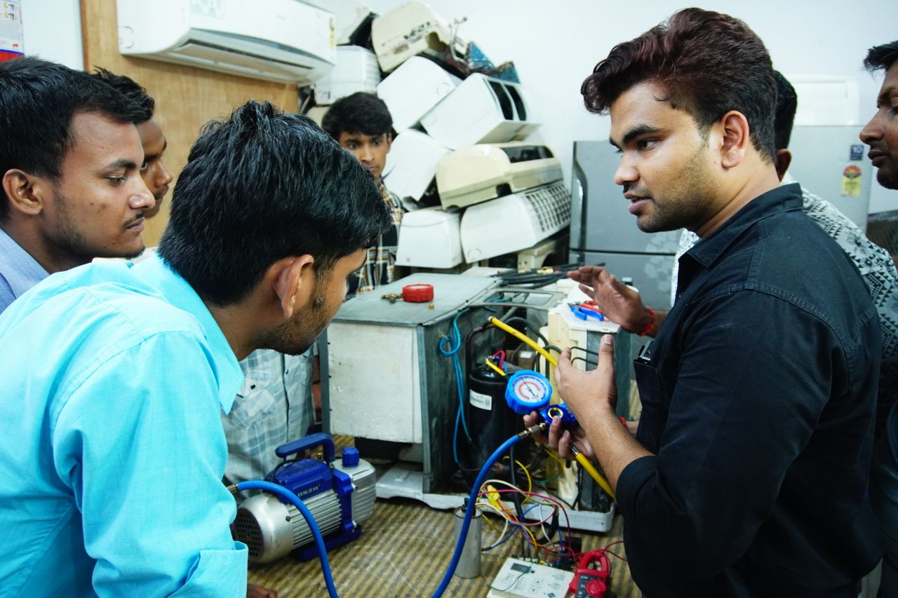 The Art of Drawing Readers In: Your attractive post title goes here Participants learn AC repair during a hands-on session in Delhi, India.
